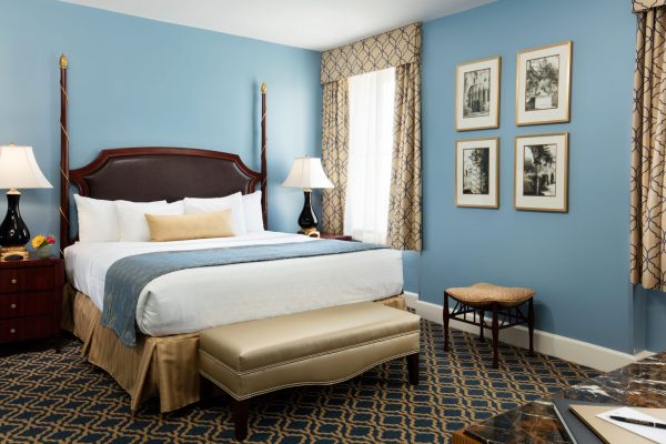 A bedroom is shown with blue and gold accents.